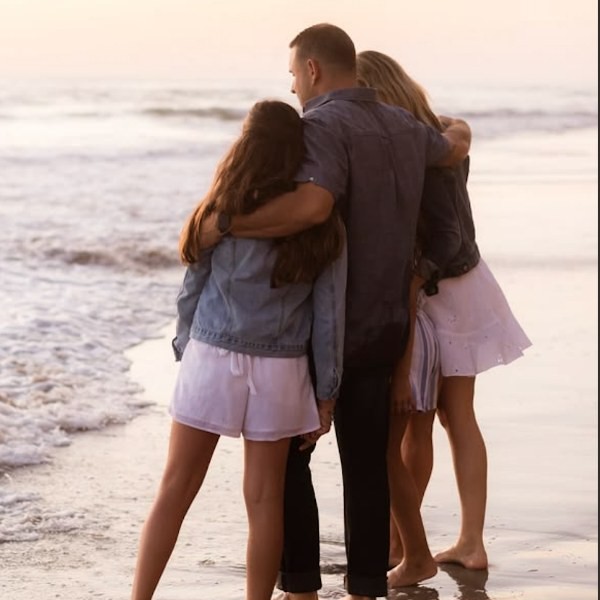 A family at the shoreline, printed as a photo coaster