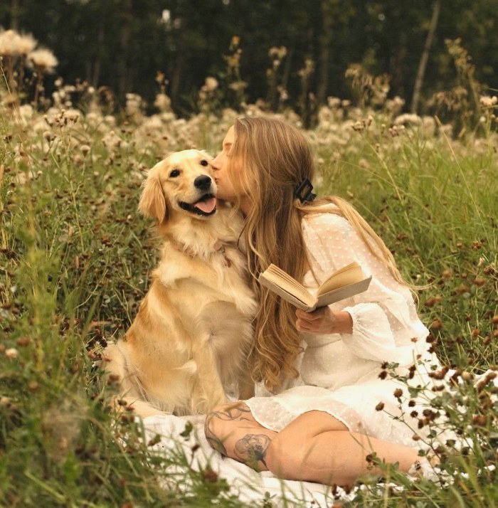 A girl and her dog in a summer field, printed as a photo magnet